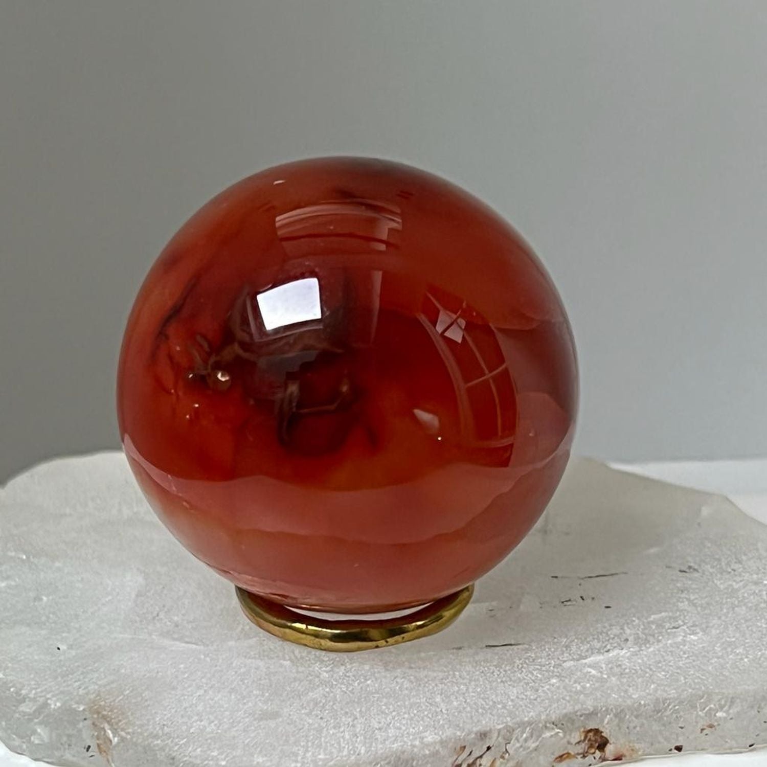 Unique Carnelian ball from Madagascar with brass ring stand