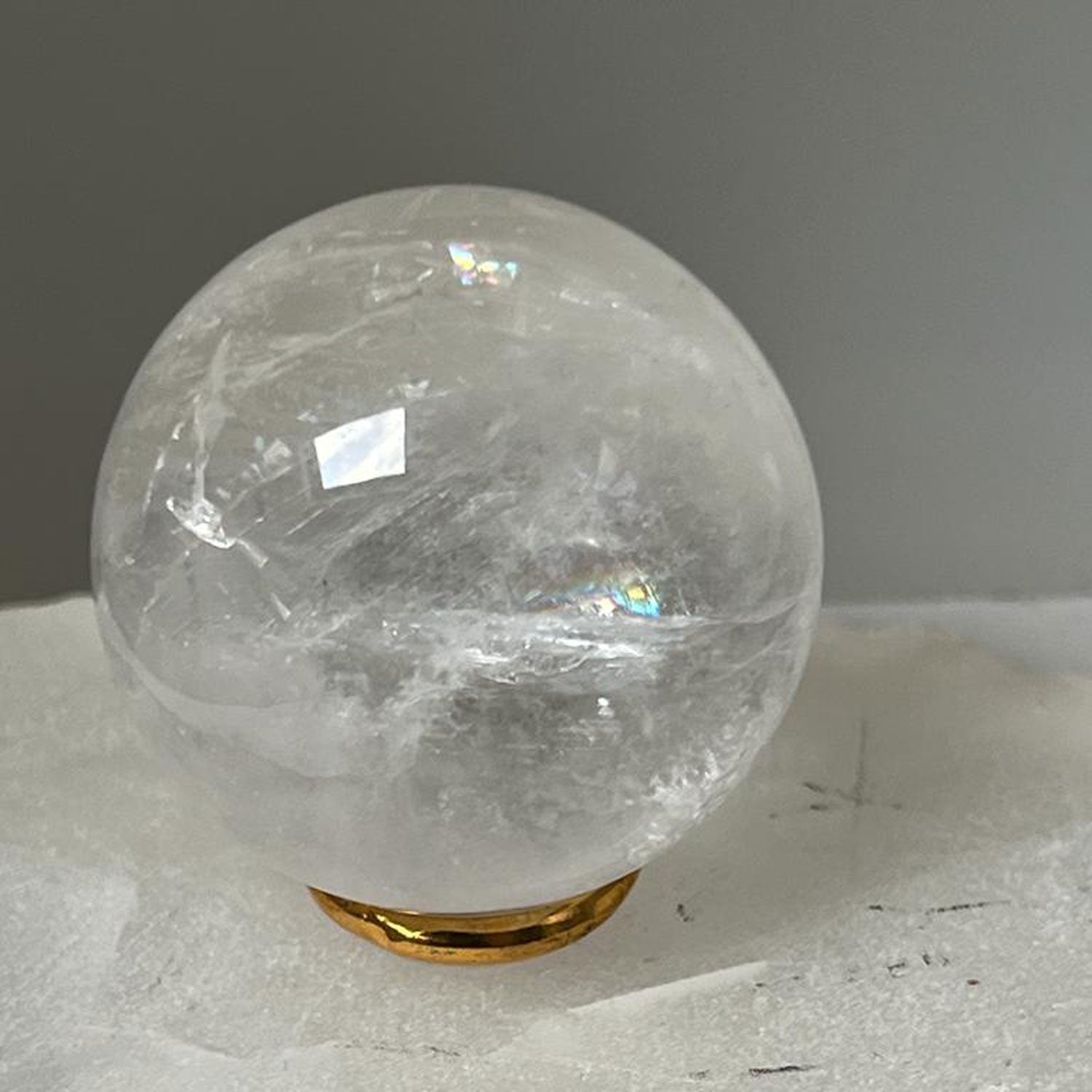 Unique Rock crystal ball with brass ring stand from Madagascar