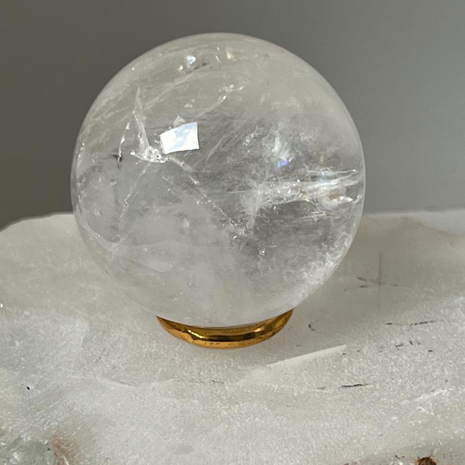 Unique Rock crystal ball with brass ring stand from Madagascar