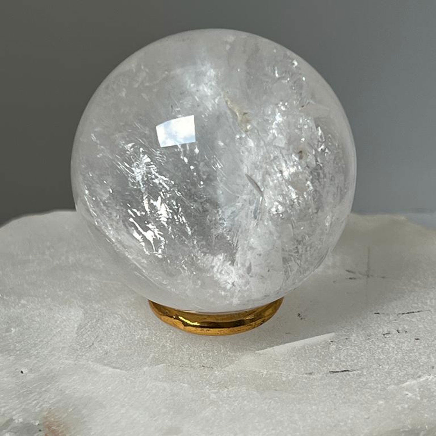 Unique Rock crystal ball with brass ring stand from Madagascar