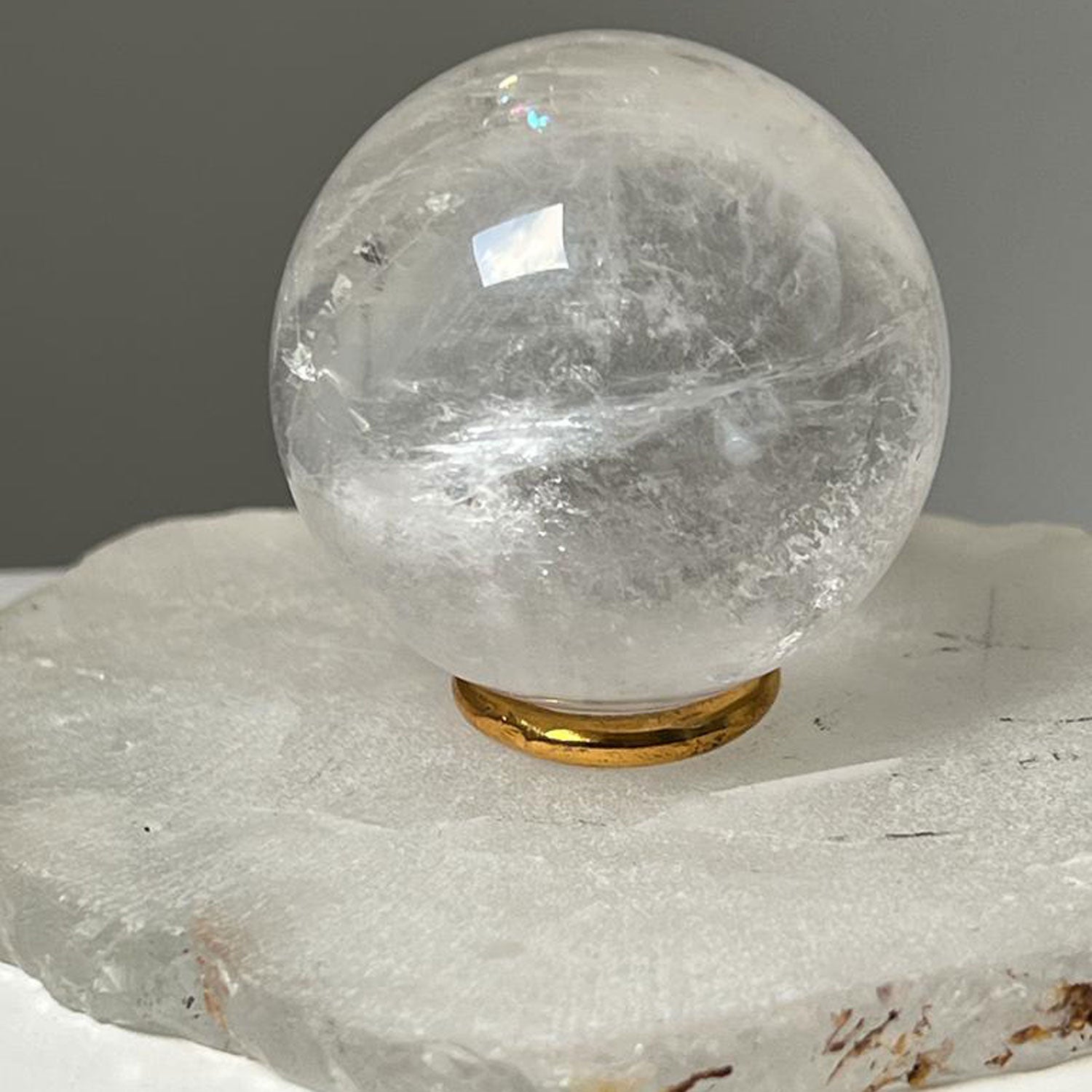 Unique Rock crystal ball with brass ring stand from Madagascar