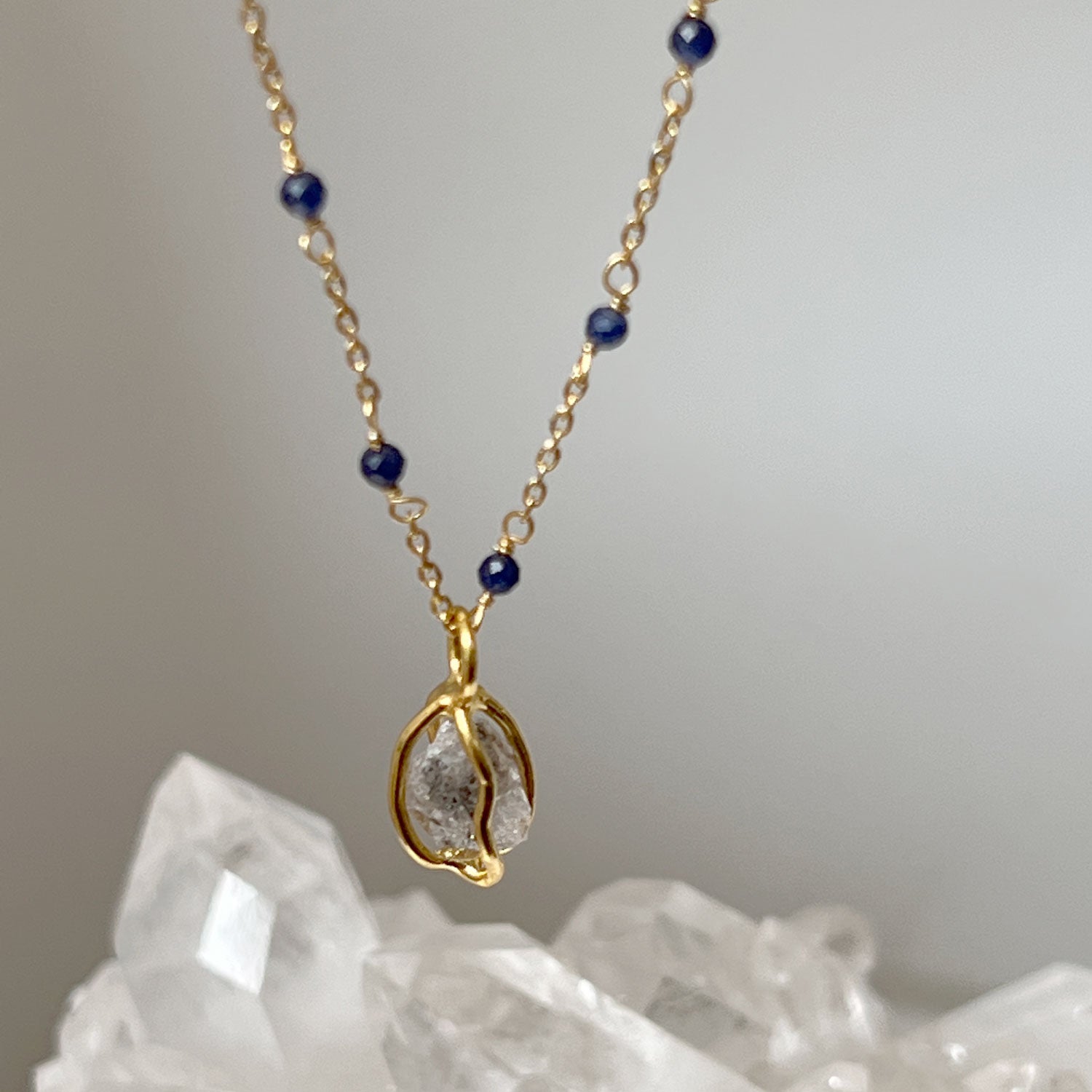 Fancy Sapphire rosary with Herkimer diamond raw in cage pendant